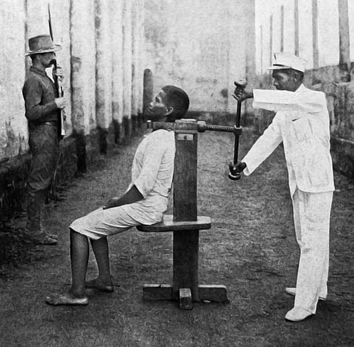 Horrible stories of olden days government 1 This is a picture of a man who is about to be executed using the execution device called the garrote. This is a picture of a man who is about to be executed using the execution device called the garrote. Horrible stories of olden days government