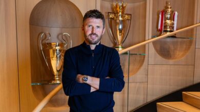 Michael Carrick appointed Man Utd interim manager standing before a trophy cabinet